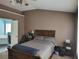 This main bedroom offers a ceiling fan and views of the ensuite bathroom at 1117 Balvaird Dr, Lawrenceville, GA 30045