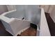Staircase with wood floors, white banister, and light-grey painted walls at 1117 Balvaird Dr, Lawrenceville, GA 30045