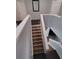 Staircase with wood floors, white banister, and light-grey painted walls at 1117 Balvaird Dr, Lawrenceville, GA 30045