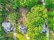 Aerial view of a home with lush green surroundings and a spacious tree-filled yard at 118 Greenwood St, Fairburn, GA 30213