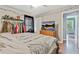 Bedroom with wooden floors, a large bed, a ceiling fan, and a flat-screen TV at 118 Greenwood St, Fairburn, GA 30213