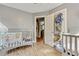 Comfortable Bedroom featuring two cribs and closet, with refinished wood flooring and neutral paint at 118 Greenwood St, Fairburn, GA 30213