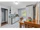 Efficient kitchen with white cabinetry, tile floors, and a cozy dining area at 118 Greenwood St, Fairburn, GA 30213