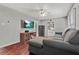 Spacious living room with hardwood floors, a cozy sectional sofa, and modern entertainment setup at 118 Greenwood St, Fairburn, GA 30213