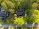 Aerial view of the home showcasing lush greenery, a swimming pool and the surrounding neighborhood at 375 Spindle Ct, Sandy Springs, GA 30350