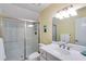 Bright bathroom features white tiles, glass shower doors and a sleek vanity with stainless steel hardware at 375 Spindle Ct, Sandy Springs, GA 30350