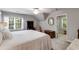 A cozy bedroom with a ceiling fan and natural light, and access to an en-suite bathroom at 375 Spindle Ct, Sandy Springs, GA 30350