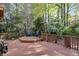Large wooden deck surrounded by lush greenery featuring outdoor seating, ideal for relaxing and entertaining at 375 Spindle Ct, Sandy Springs, GA 30350