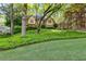 Charming home with lush greenery, trees, and lawn creating curb appeal and an inviting landscape at 375 Spindle Ct, Sandy Springs, GA 30350