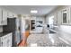 Bright kitchen with stainless steel appliances, granite countertops, and white cabinets at 375 Spindle Ct, Sandy Springs, GA 30350