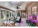 Bright sunroom features tile floor, multiple windows, wicker chairs, and a skylight for natural light at 375 Spindle Ct, Sandy Springs, GA 30350