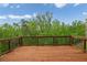 Spacious wooden deck overlooking a lush green backyard with mature trees and blue sky at 186 Greenbrier Way, Canton, GA 30114