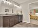 Bathroom featuring a large vanity, dual sinks, and a view into the bedroom at 186 Greenbrier Way, Canton, GA 30114