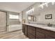 Bathroom featuring a large vanity, soaking tub, and glass enclosed shower at 186 Greenbrier Way, Canton, GA 30114