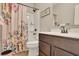 Well-lit bathroom featuring a floral shower curtain, sleek vanity, and modern fixtures for a clean look at 186 Greenbrier Way, Canton, GA 30114