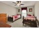 Cozy bedroom featuring two twin beds, ceiling fan and neutral-toned walls at 186 Greenbrier Way, Canton, GA 30114