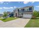 Beautiful two-story home showcasing a well-kept lawn and a long driveway leading to the garage at 186 Greenbrier Way, Canton, GA 30114