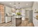 Bright kitchen with white cabinets, stainless steel appliances, kitchen island, and hardwood floors at 186 Greenbrier Way, Canton, GA 30114