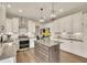 Beautiful kitchen with white cabinets, stainless steel appliances, kitchen island, and hardwood floors at 186 Greenbrier Way, Canton, GA 30114