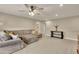 Bright upstairs living room featuring a comfortable sectional sofa, window, and fan at 186 Greenbrier Way, Canton, GA 30114
