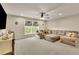 Bright upstairs living room featuring a comfortable sectional sofa, window, and fan at 186 Greenbrier Way, Canton, GA 30114