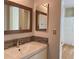 Bathroom showcasing a single vanity with double decorative mirrors and tiled walls at 199 14Th Ne St # 710, Atlanta, GA 30309