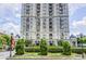 Elegant high-rise building featuring multiple balconies and manicured landscaping at 199 14Th Ne St # 710, Atlanta, GA 30309