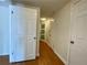 Hallway with hardwood floors, white doors, and access to multiple rooms at 199 14Th Ne St # 710, Atlanta, GA 30309