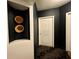 Hallway featuring dark paint, contrasting white door, niche with round decorative pieces, and patterned carpet at 199 14Th Ne St # 710, Atlanta, GA 30309