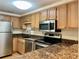 Kitchen featuring stainless steel appliances, granite countertops, and wood cabinets at 199 14Th Ne St # 710, Atlanta, GA 30309