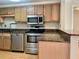 Kitchen featuring stainless steel appliances, granite countertops, and wood cabinets at 199 14Th Ne St # 710, Atlanta, GA 30309