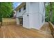 A spacious wooden deck offers ample outdoor entertaining space with a sliding glass door to enter the home at 2551 Park Se Rd, Smyrna, GA 30080