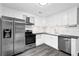 Modern kitchen with stainless steel appliances, granite countertops, and white cabinetry at 2551 Park Se Rd, Smyrna, GA 30080