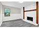 Cozy living room featuring a stone fireplace, hardwood floors, and natural light from a window at 2551 Park Se Rd, Smyrna, GA 30080