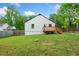 View of the home's back exterior and a wooden deck overlooking the backyard at 428 Tibbetts Se St, Marietta, GA 30060