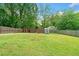 Spacious backyard featuring multiple storage sheds and a wood fence at 428 Tibbetts Se St, Marietta, GA 30060
