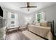 Bright bedroom with a twin bed, wood floors, and stylish ceiling fan at 428 Tibbetts Se St, Marietta, GA 30060