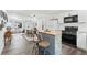 Open concept kitchen with a central island, bar stool seating, and modern appliances at 428 Tibbetts Se St, Marietta, GA 30060
