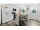 Bright kitchen featuring white cabinets, stainless appliances, and an island with seating at 428 Tibbetts Se St, Marietta, GA 30060