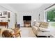 Comfortable living room featuring modern furniture, natural light, and hardwood floors at 428 Tibbetts Se St, Marietta, GA 30060