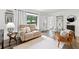 Bright living room featuring a comfortable loveseat, leather chair, and large window at 428 Tibbetts Se St, Marietta, GA 30060