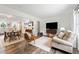Open-concept living room with dining area and hardwood flooring for seamless entertaining at 428 Tibbetts Se St, Marietta, GA 30060