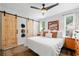 Bright main bedroom showcasing sliding barn doors, neutral tones, and refined decor at 428 Tibbetts Se St, Marietta, GA 30060