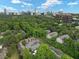 Aerial view showing the residential neighborhood and skyline, with lush green trees and ample parking at 95 Ivy Ne Trl, Atlanta, GA 30342