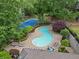 Aerial shot of community pool and tennis court area with lounge chairs at 95 Ivy Ne Trl, Atlanta, GA 30342