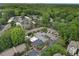 Aerial view of a multi-Gathering residential complex surrounded by mature trees and ample parking at 95 Ivy Ne Trl, Atlanta, GA 30342
