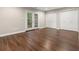 Spacious finished basement with luxury vinyl plank flooring and walkout doors at 95 Ivy Ne Trl, Atlanta, GA 30342