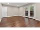 Finished basement featuring laminate flooring and walk-out double doors at 95 Ivy Ne Trl, Atlanta, GA 30342
