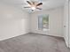 Spacious bedroom with carpet flooring, ceiling fan, and natural light from a window at 95 Ivy Ne Trl, Atlanta, GA 30342