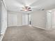 Bedroom featuring plush carpeting, ceiling fan, and ample closet space at 95 Ivy Ne Trl, Atlanta, GA 30342